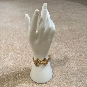 Faux gold/diamond bow bracelet.